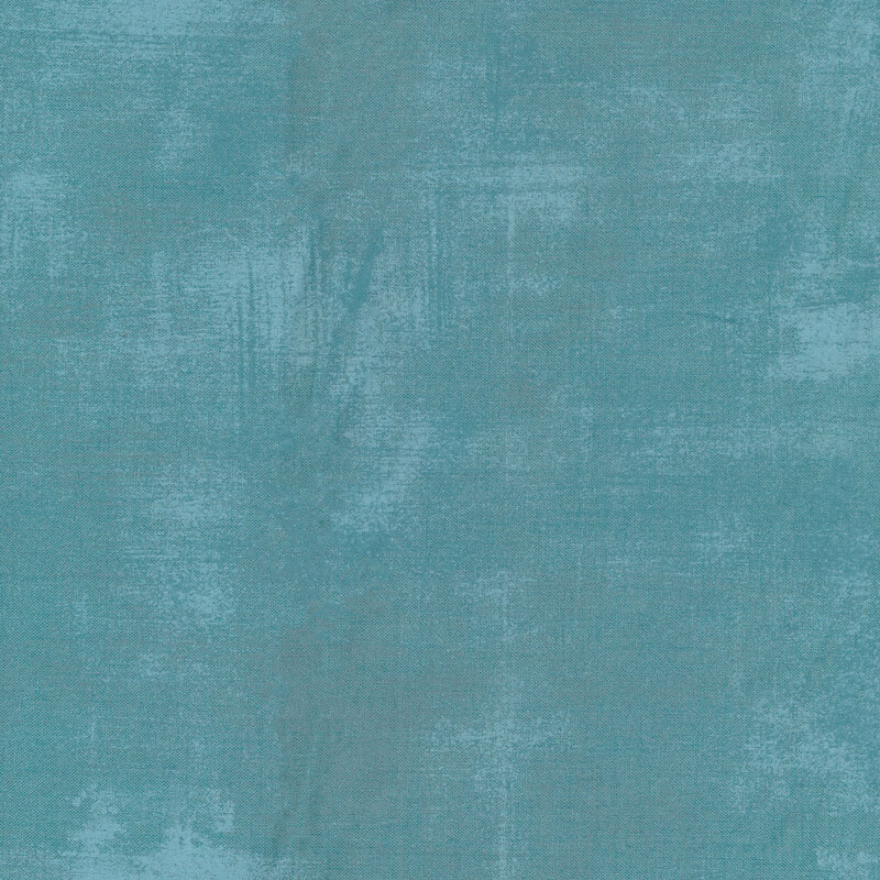 A pale blue teal grunge textured fabric
