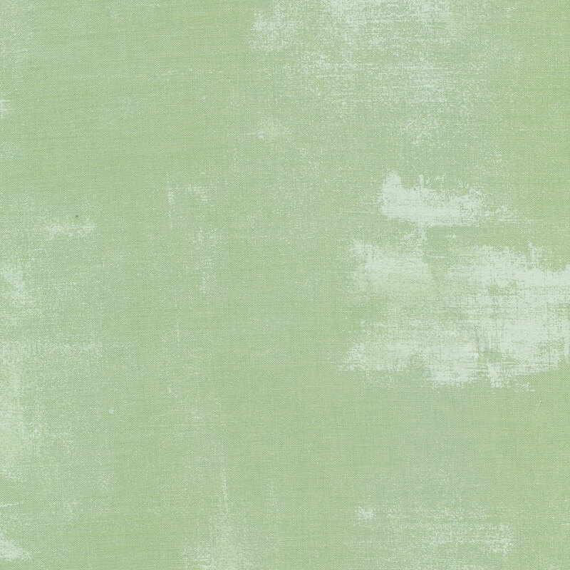 A pale green grunge textured fabric