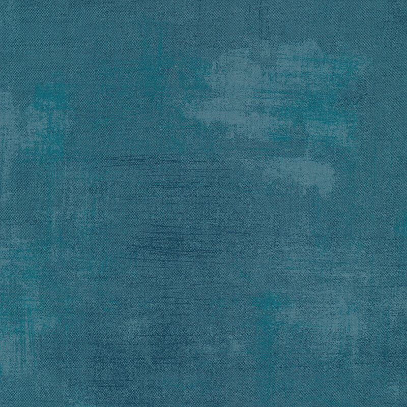 A blueberry blue fabric with bits of pale blue grunge texturing