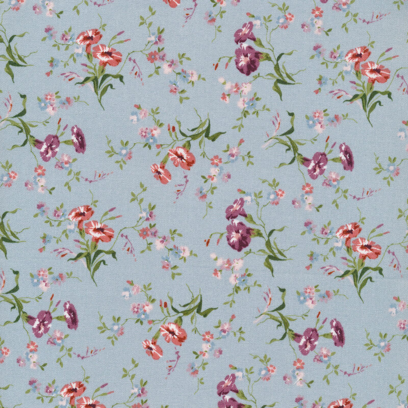 Fabric with tossed florals with green leaves on a light blue background