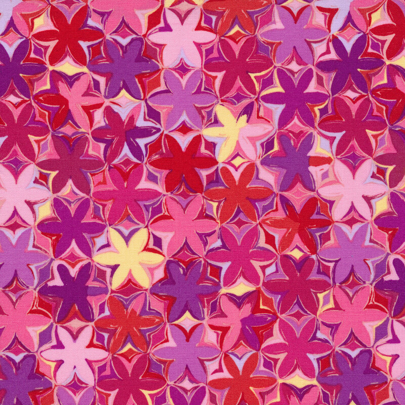 Bright pink fabric with pink, purple, yellow, red, and violet packed flowers all over