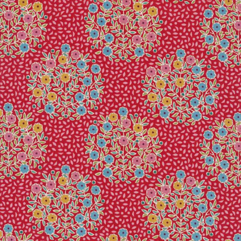 red fabric with tonal pink leaves and bunches of blue, yellow, and pink flowers with green leaves
