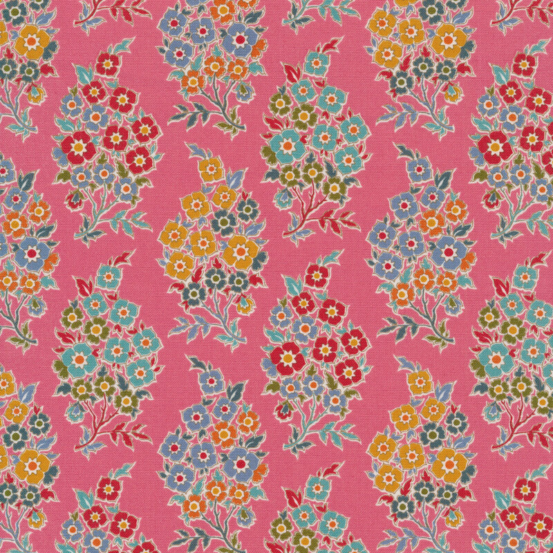 pink fabric with bunches of red, blue, green, yellow and orange flowers