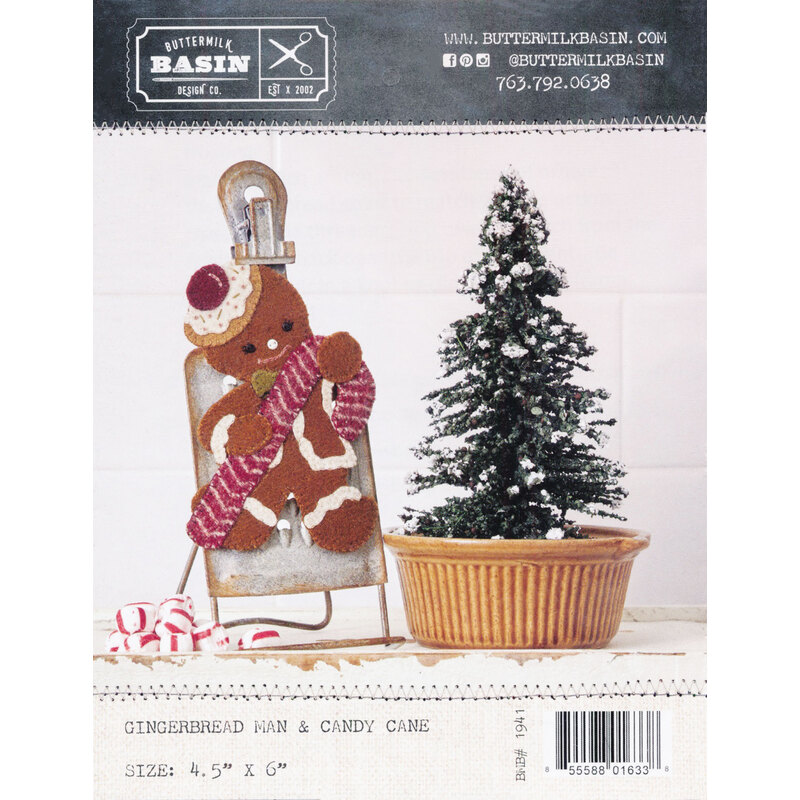 Gingerbread Man & Candy Cane Pattern front cover showing the finished project clipped to a board next to a tiny christmas tree