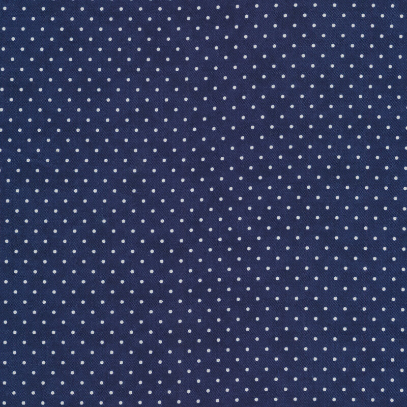 This Moda fabric features a navy blue background with off white polka dots