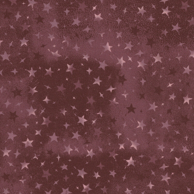 mauve mottled fabric with variegated stars in different sizes