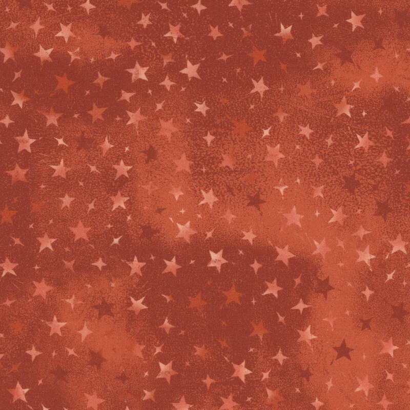 orange mottled fabric with variegated stars in different sizes