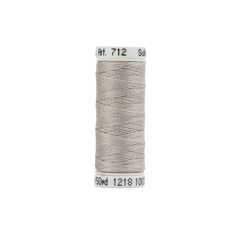 Isolated image of a single spool of Sulky petite cotton thread #1218 Silvery Gray on a white background