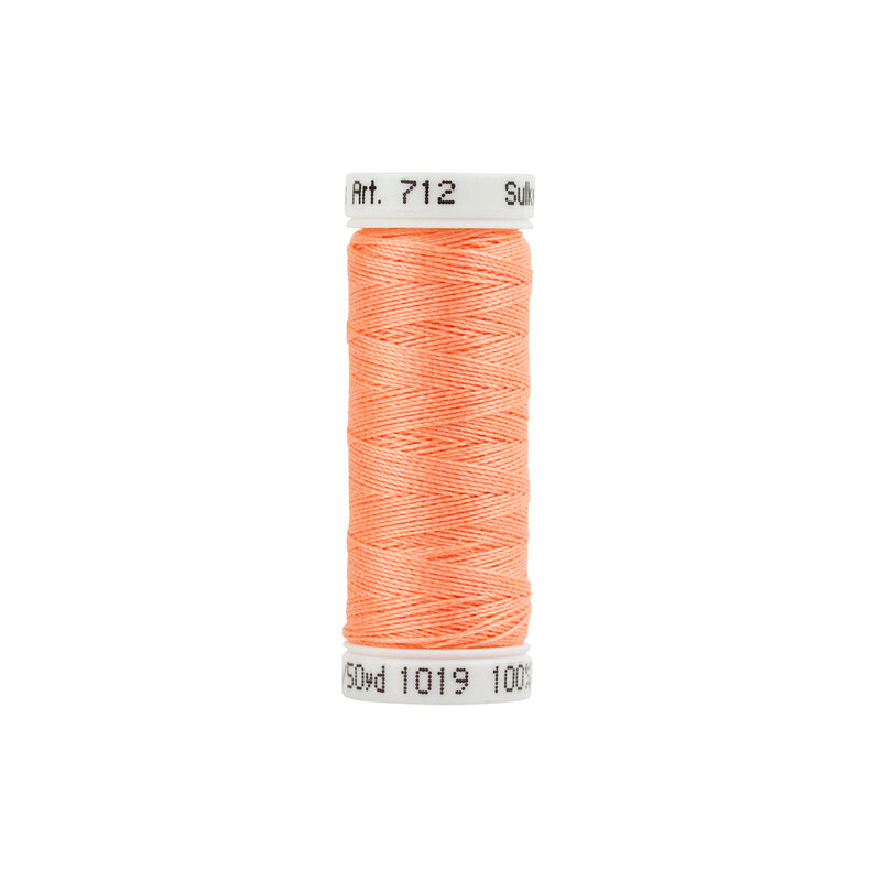 A spool of Sulky 12wt Cotton Petite #1019 Peach thread on a white background