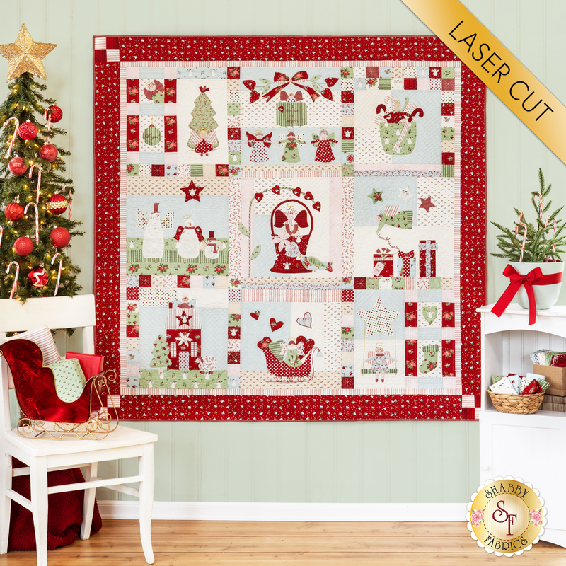 Quilt with 9 blocks of Christmas and angel themed motifs in red, white, and green fabrics.