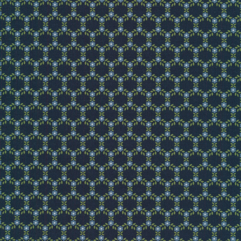 Hexagonal pattern made up of small blue flowers and green leaves on a navy background