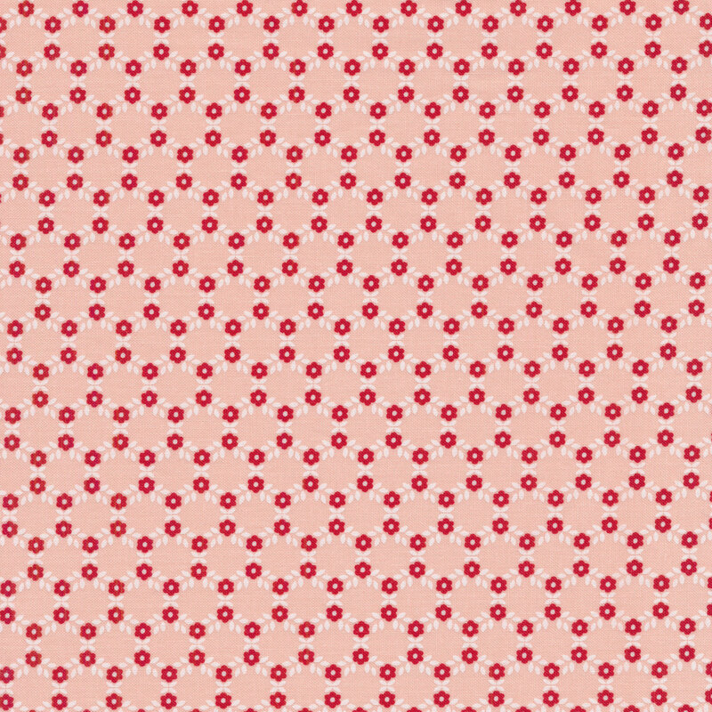 Hexagonal pattern made up of small red flowers and white leaves on a light pink background