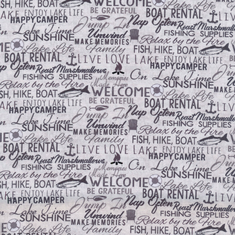 Image of gray fabric with words layered all over in gray, black, and brown with small motifs