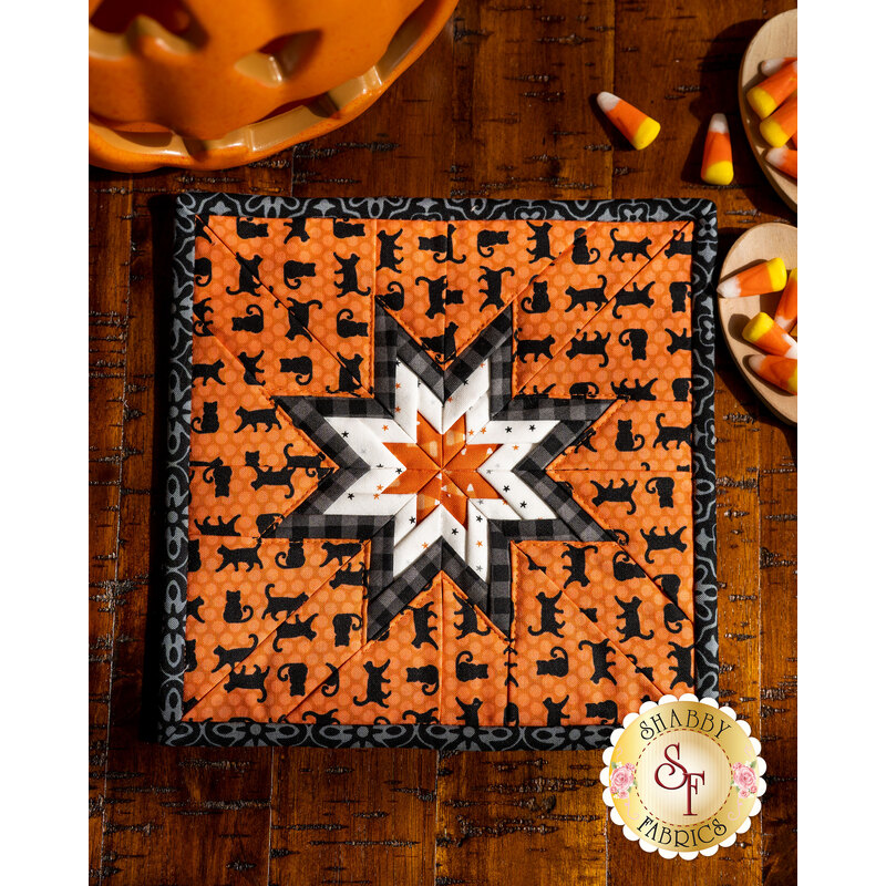 Orange Halloween themed hot pad featuring black cats along with black and white accent fabrics.