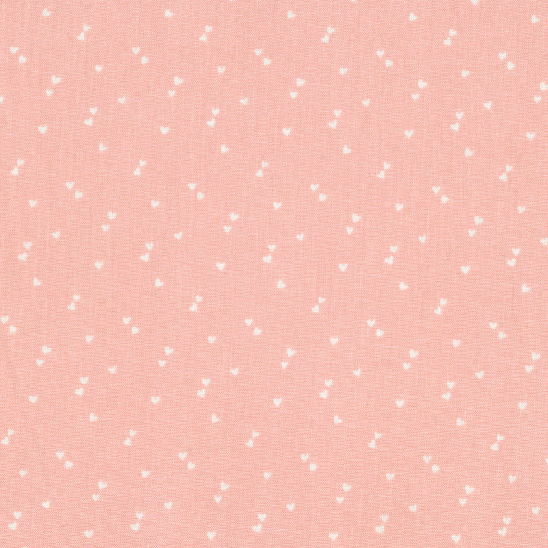 pastel pink fabric with pairs of tiny white hearts scattered all over