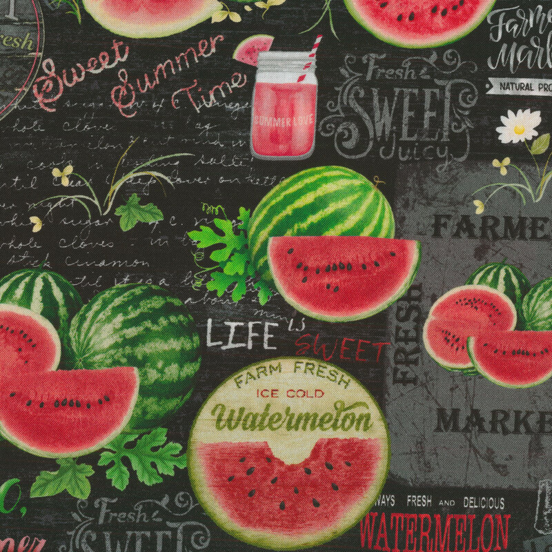 black fabric with grey handwriting and vintage fruit signage in the background with red and green cut watermelons