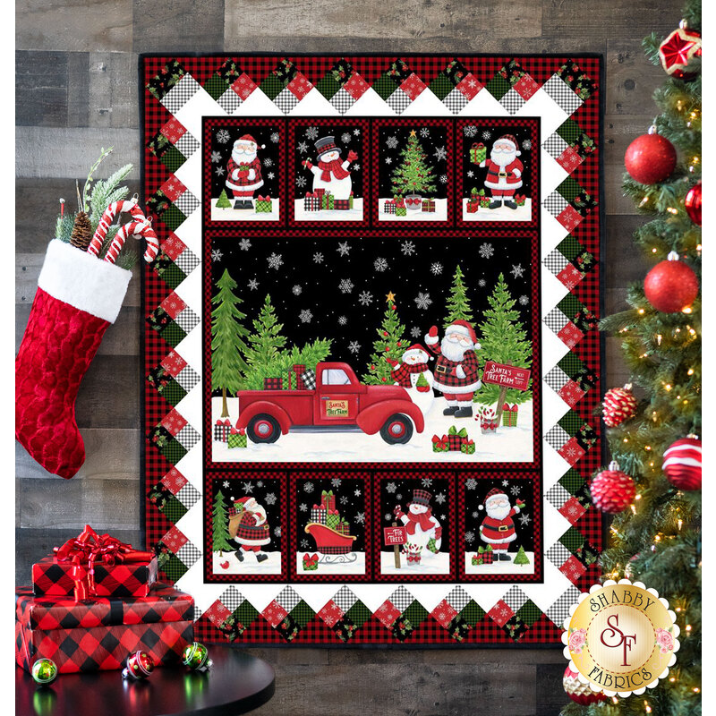Panel quilt featuring squares of Christmas themed scenes including Santa, Christmas trees, and snowmen all on black.