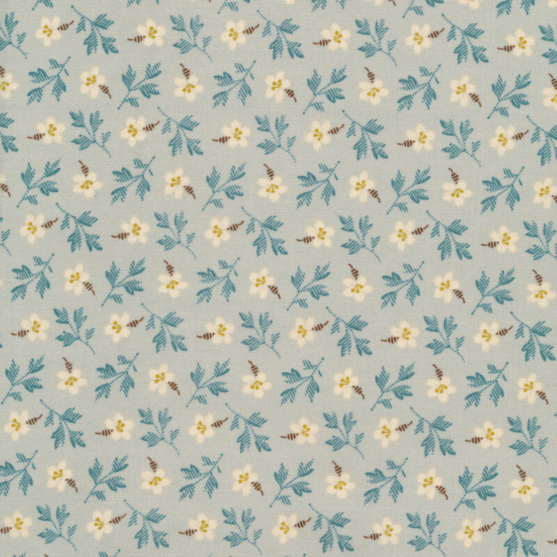 light blue fabric with cream flowers and dark blue leafy branches tossed all over