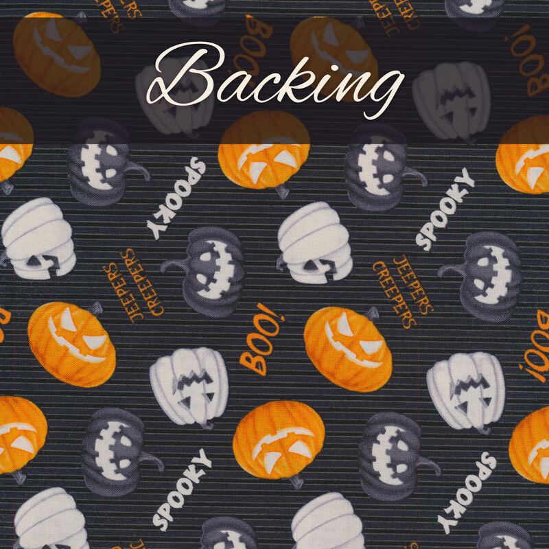 Tossed black, white, and orange jack-o-lanterns with spooky Halloween phrases on a black fabric background