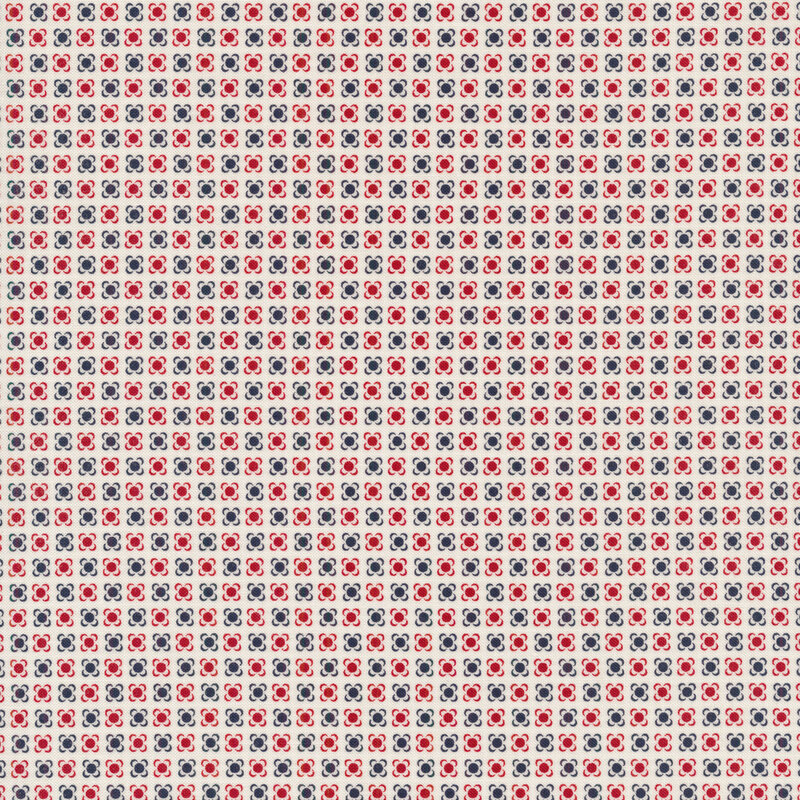 cream fabric with navy and red polka dots with small brackets around each, looking almost flower-like