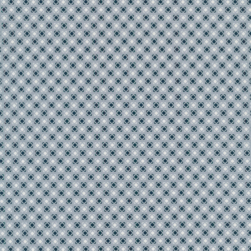 light blue fabric with navy dots with small brackets around each, looking almost flower-like with and white dots in between 