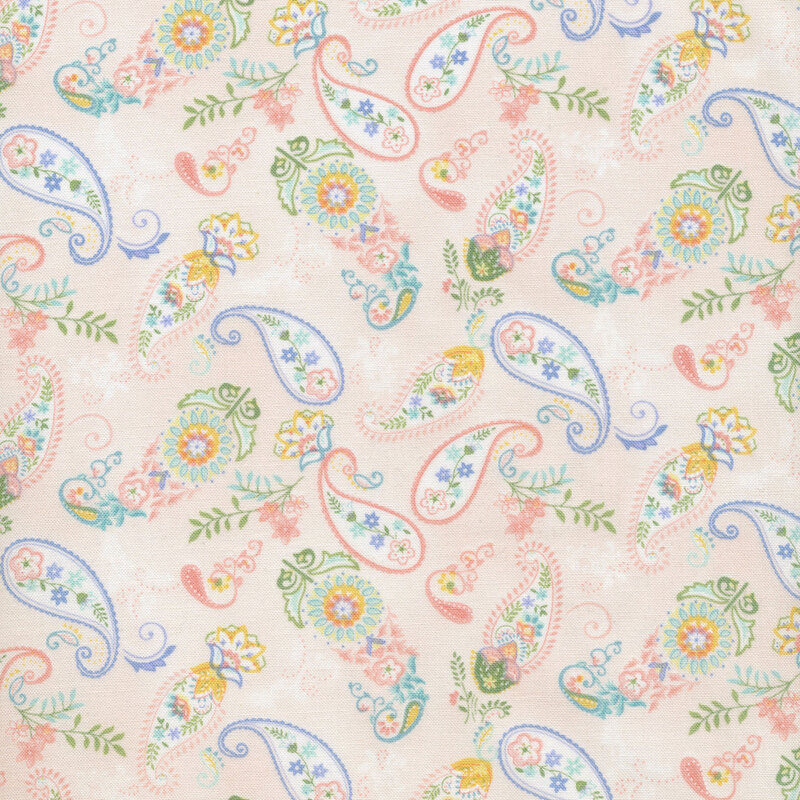 fabric with blue, green and pink florals and paisley print on a light pink background