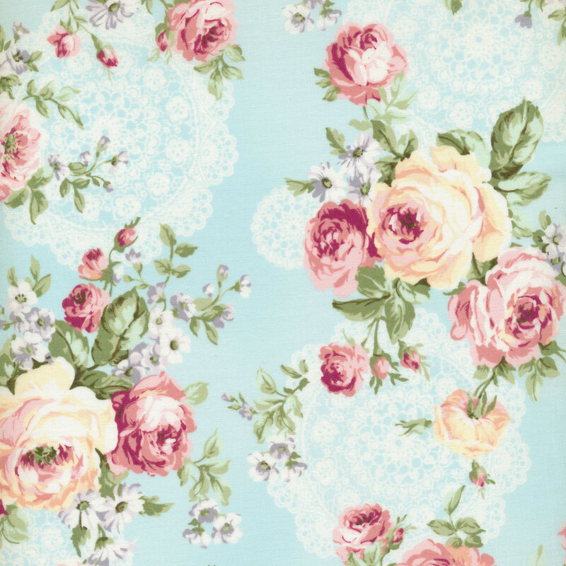 Cream and pink roses on a light blue background with cream lace