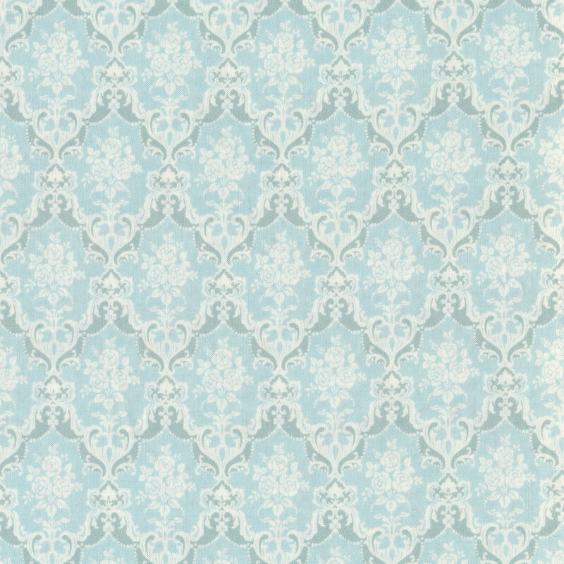 cream roses framed by cream victorian scrolls repeating on a light blue background