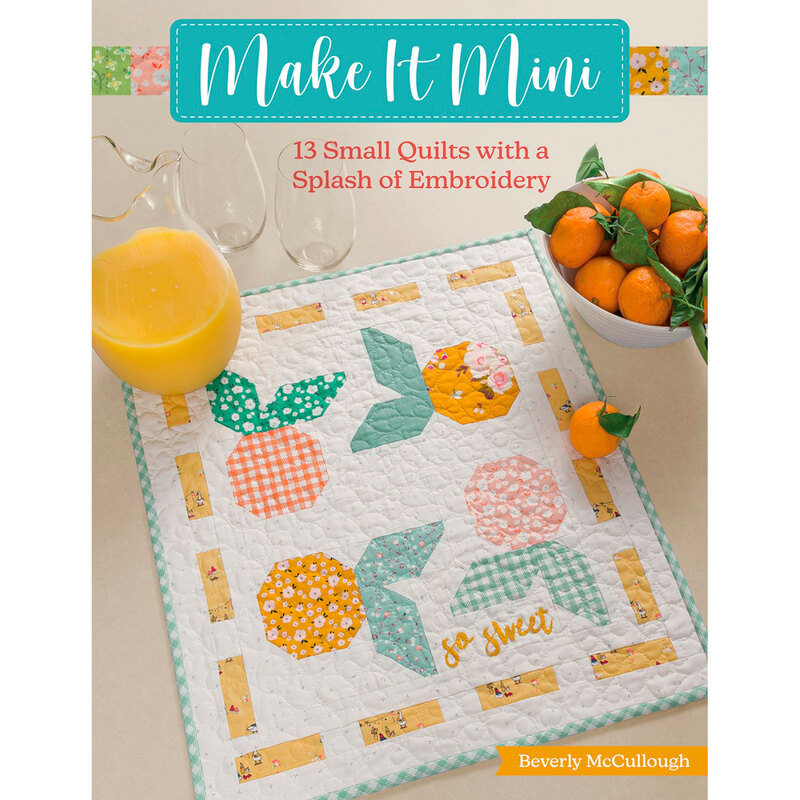front cover featuring a finished mini quilt on a table with matching citrus and a glass pitcher of orange juice