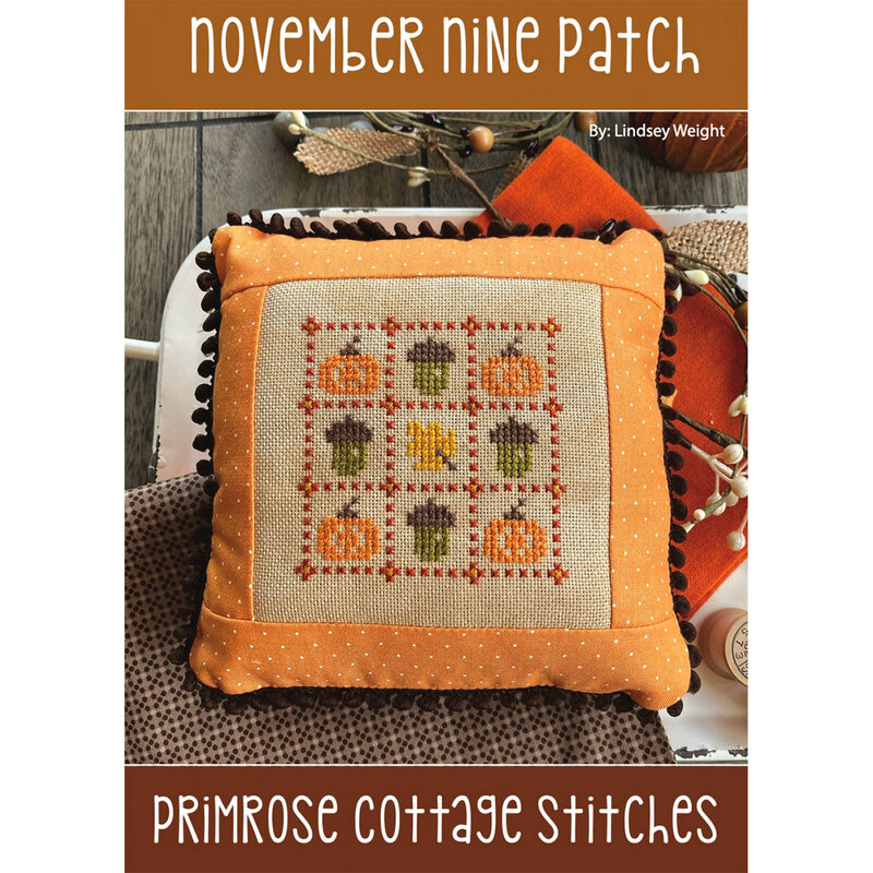 Finished pillow project featuring autumn themed cross stitch pattern