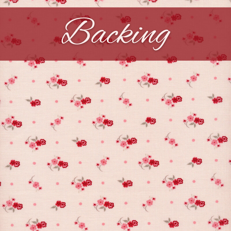 Fabric of a ditsy flower print and polka dots on a light blush background.