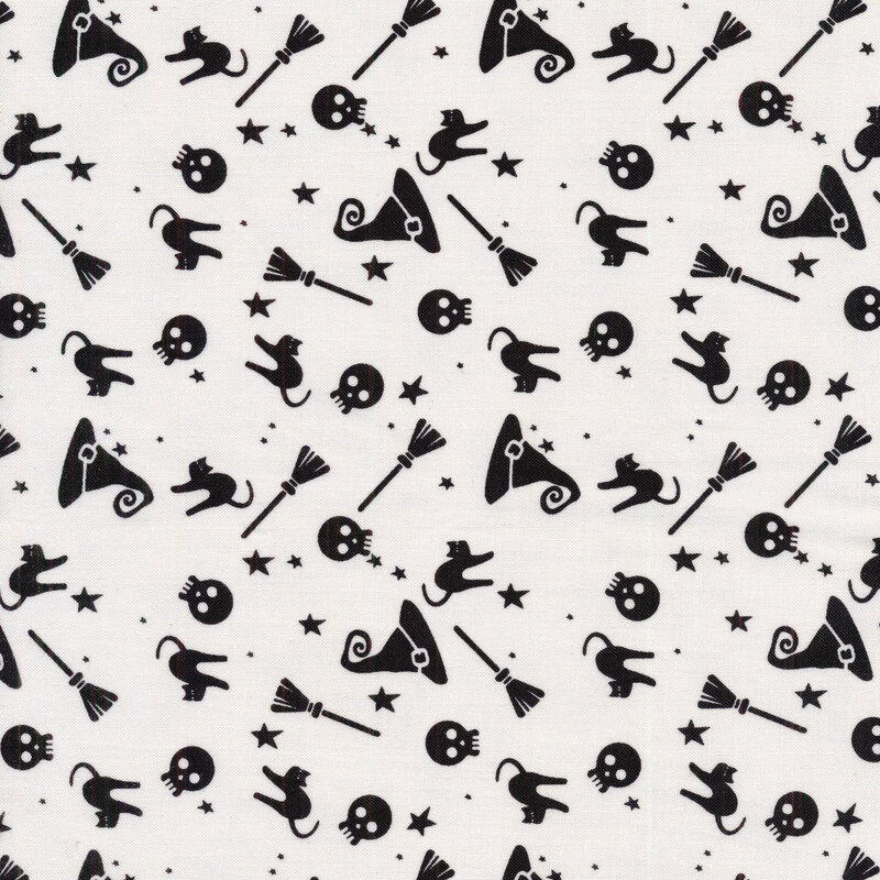 Off white fabric with black silhouettes of brooms, skulls, witch hats, black cats, and stars