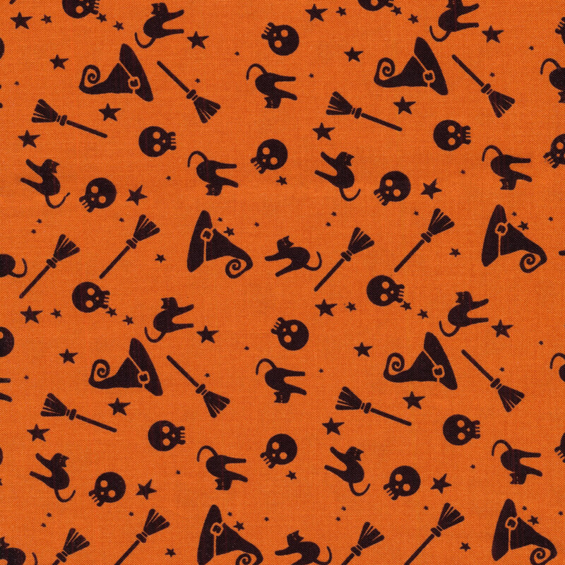 Orange fabric with black silhouettes of brooms, skulls, witch hats, black cats, and stars
