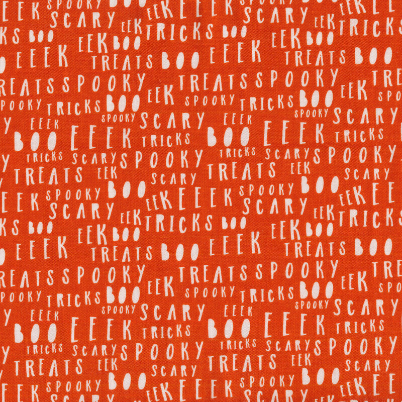 Orange fabric with white lettering all over with Halloween associated words like 