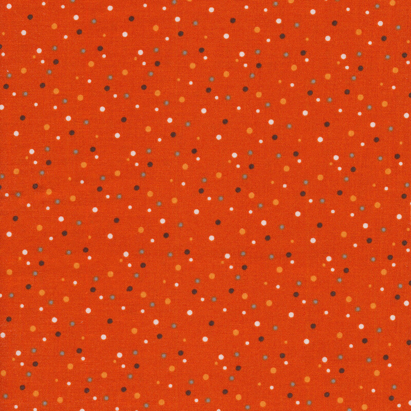 Orange fabric with white, orange, and black dots all over