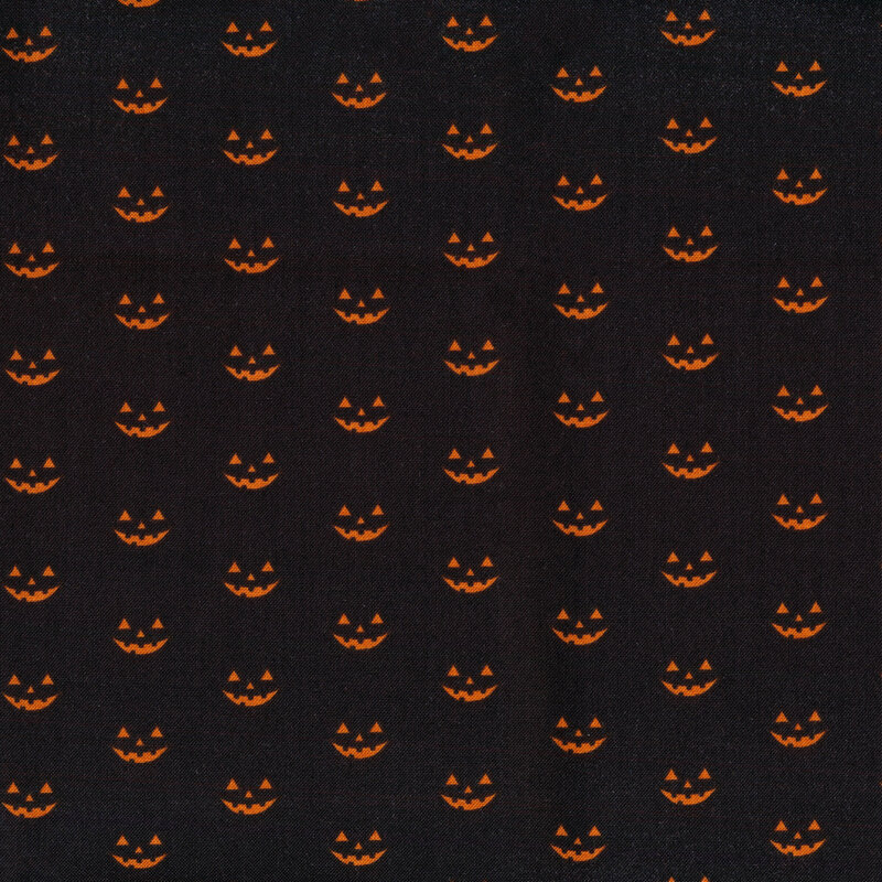 Black fabric with rows of staggered orange jack o'lantern faces