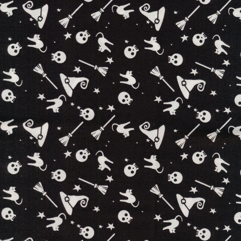 black fabric with white silhouettes of brooms, skulls, witch hats, black cats, and stars