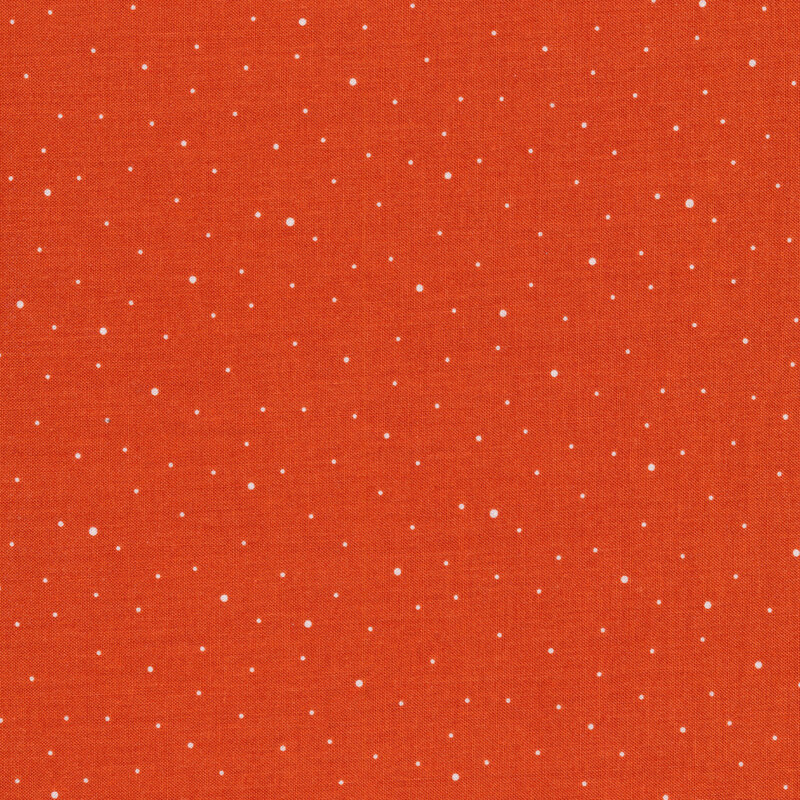 Burnt orange fabric with irregular tiny white dots
