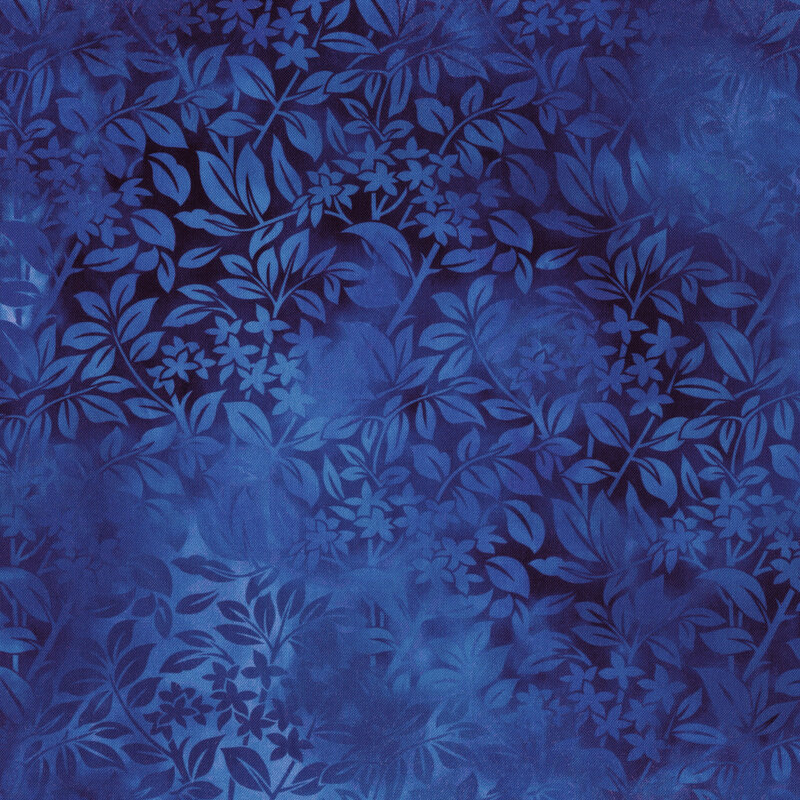 Variegated blue fabric with overlapping tonal leaves all over