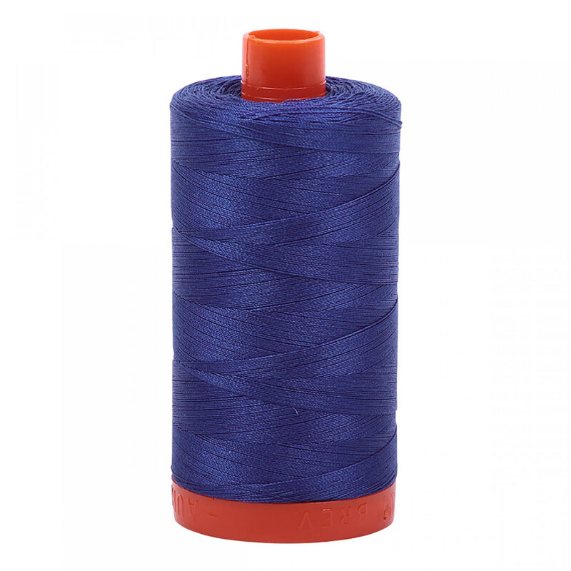 A spool of Aurifil 2735 - Medium Blue thread on a white background