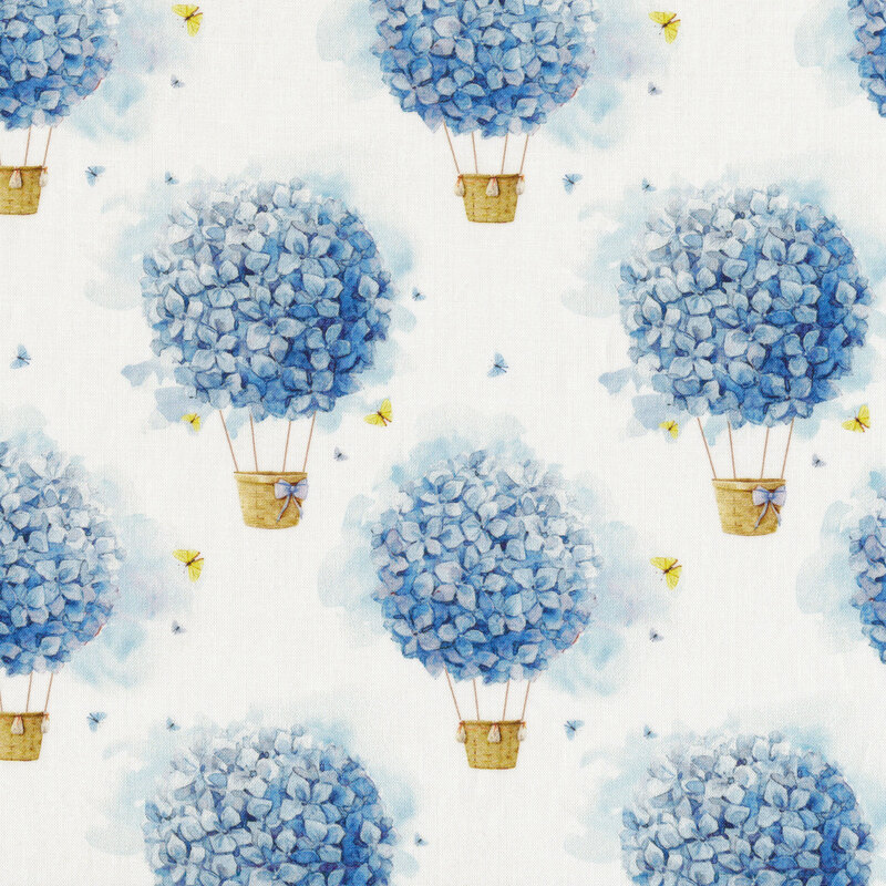 White fabric with surreal hot air balloons made up of blue flowers and hanging baskets with tiny butterflies between them