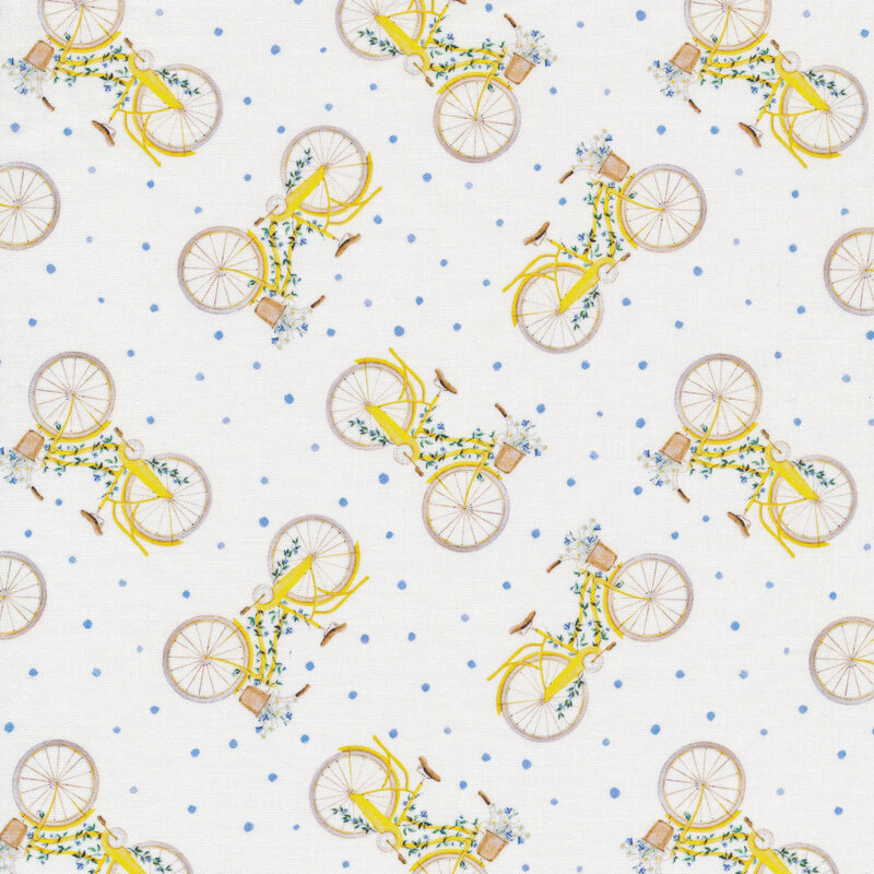 White fabric with tossed small blue dots and yellow bicycles draped with blue flowers on green vines