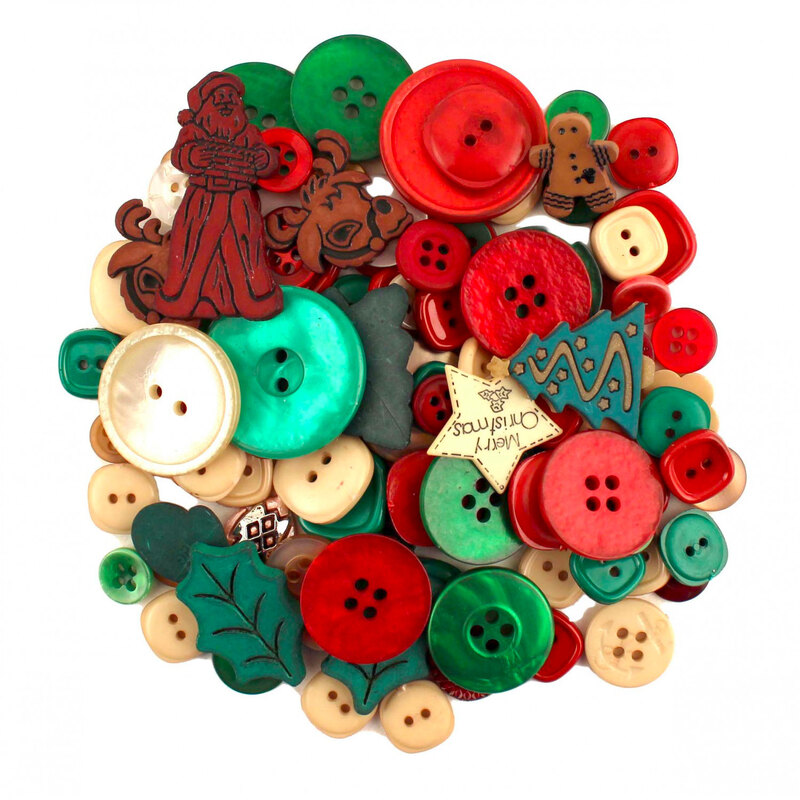 Isolated pile of red and green Christmas themed buttons against a white background