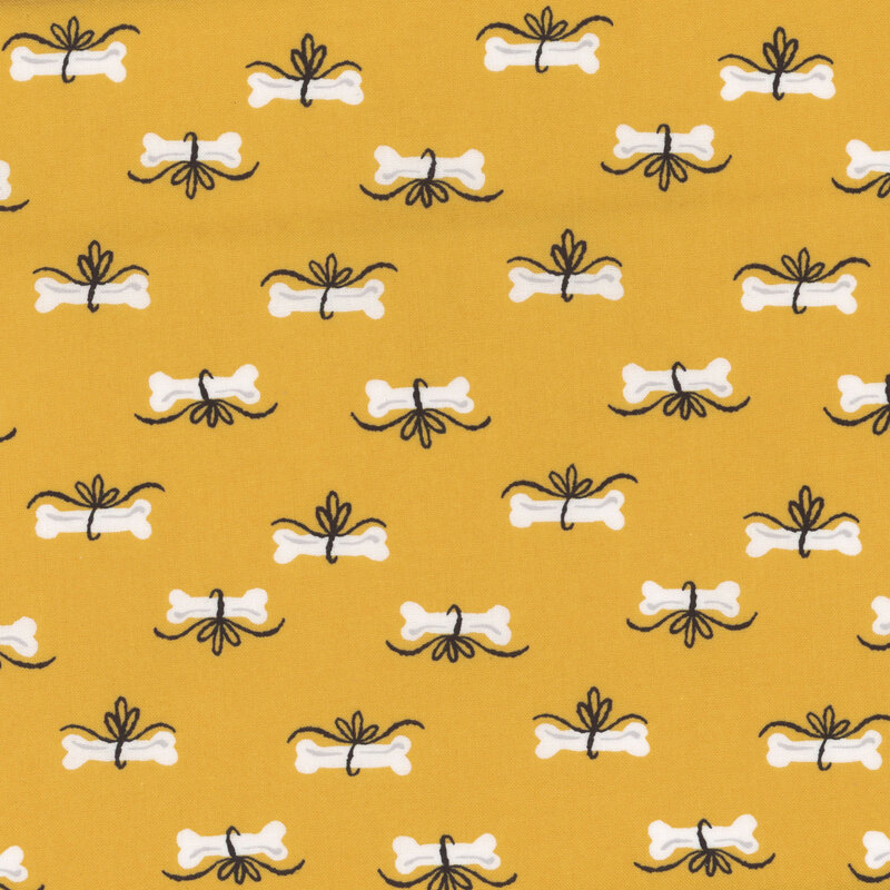 Fabric with white dog bones with black bows on a golden yellow background