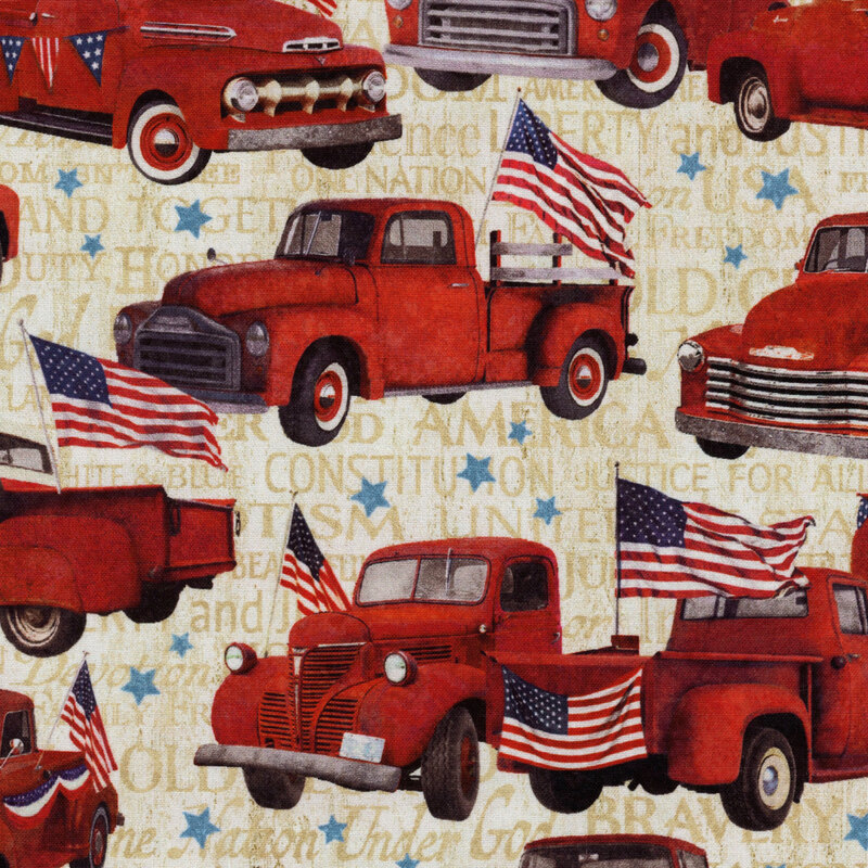 An off white fabric covered in red vintage trucks with stars and American flags