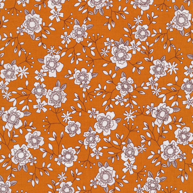 Burnt orange fabric with small black and white white flowers all over