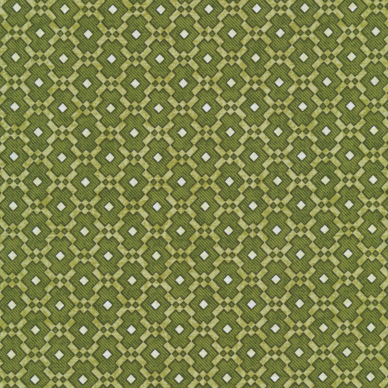 Green fabric with a geometric tiled pattern and small white squares