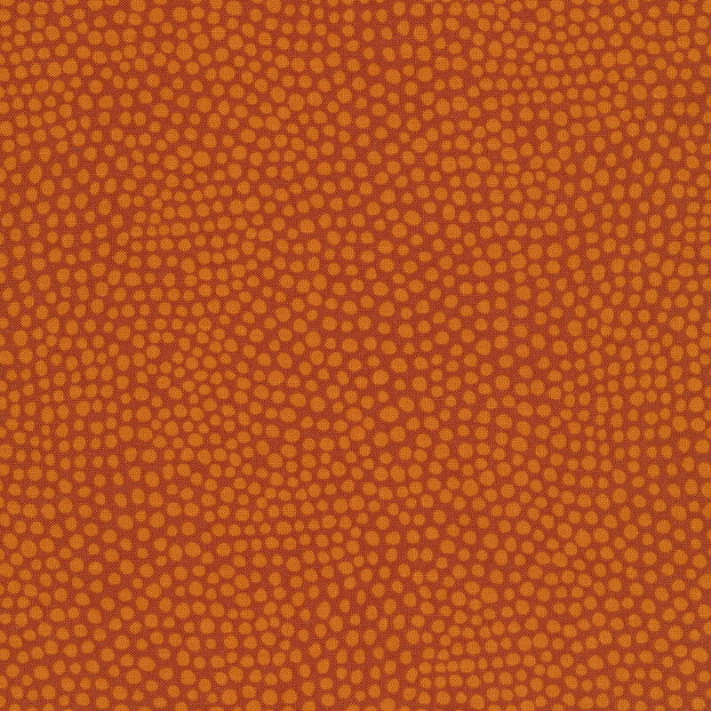 Burnt orange fabric with small light orange spots all over