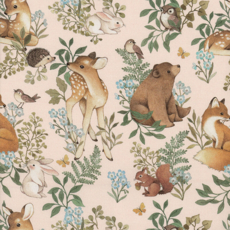 Pale pink fabric with woodland creatures and green ferns and plants all over