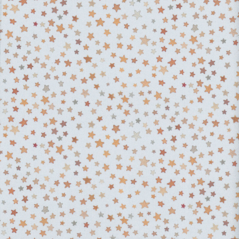 pale blue fabric with small stars all over in shades of brown and yellow